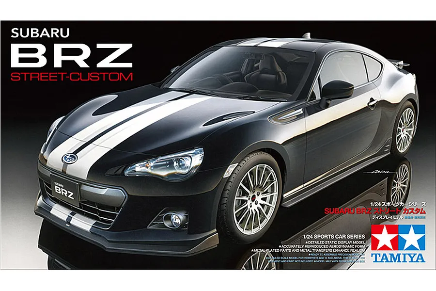 Box art for Tamiya 1/24 scale Subaru BRZ Street-Custom plastic model kit, featuring a black car with white racing stripes on a dark background.