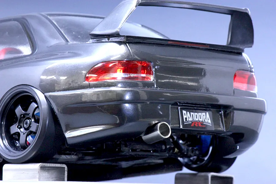Rear close-up view of the Pandora RC Subaru Impreza 22B STi body shell, showcasing the rear wing, exhaust tip, and licence plate.