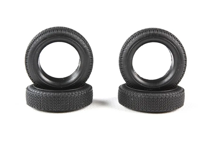 Four black rubber model car tires arranged in two stacks of two against a white background.