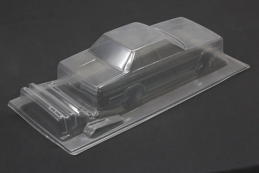 Unpainted clear polycarbonate RC car body shell for a Toyota Cresta GX71 on a black background.
