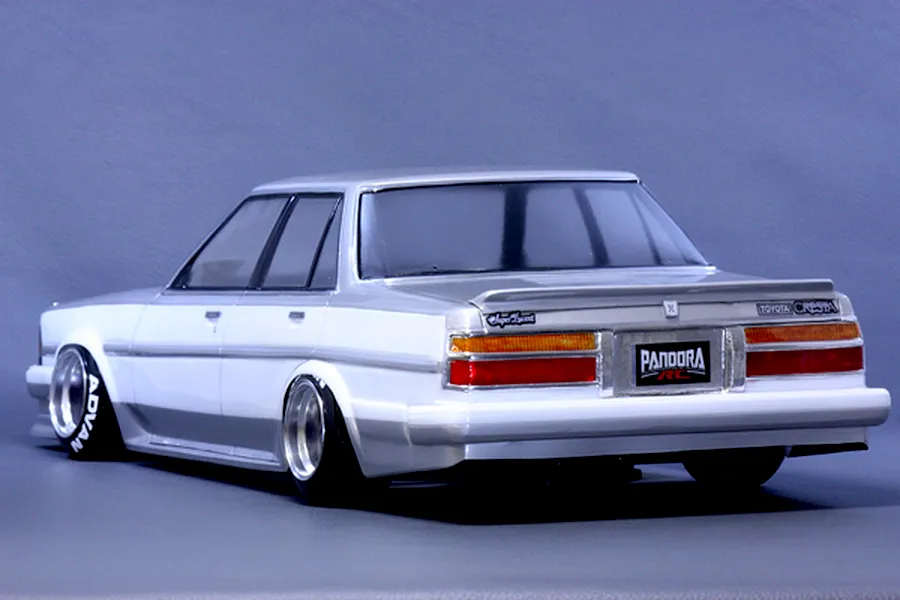 Rear three-quarter view of a Pandora RC Toyota Cresta GX71 RC drift car body shell painted white and silver with deep dish wheels.