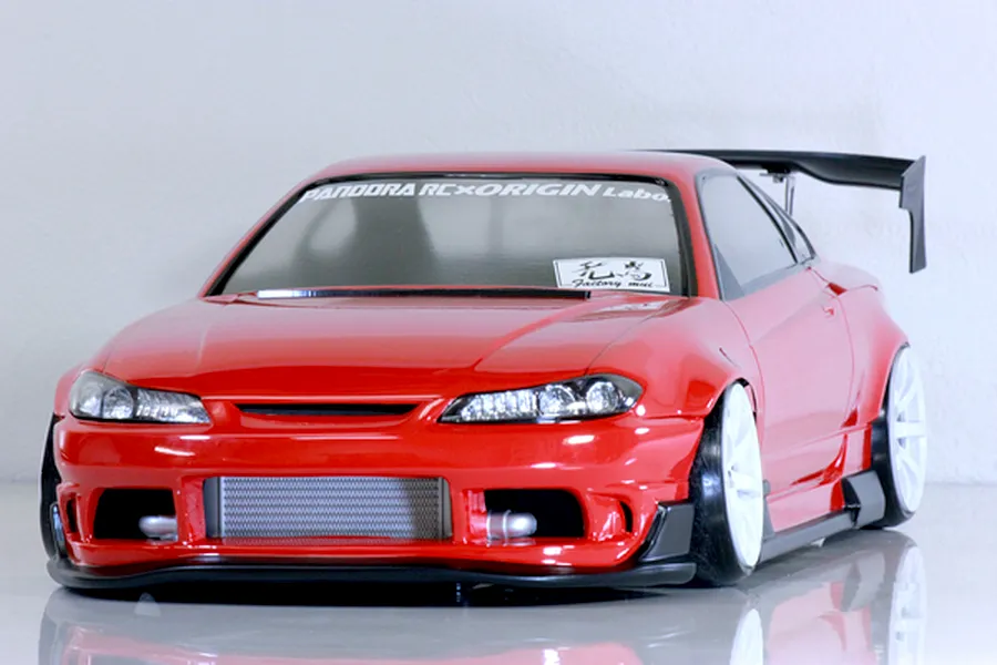 Red Pandora RC S13 Silvia Origin Labo RC car body with white wheels, black wing, and front mount intercooler detail.