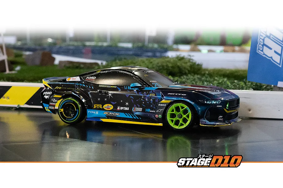HPI Stage-D10 Ford Mustang GT RC drift car driving on an indoor track with neon green wheels and sponsor decals.