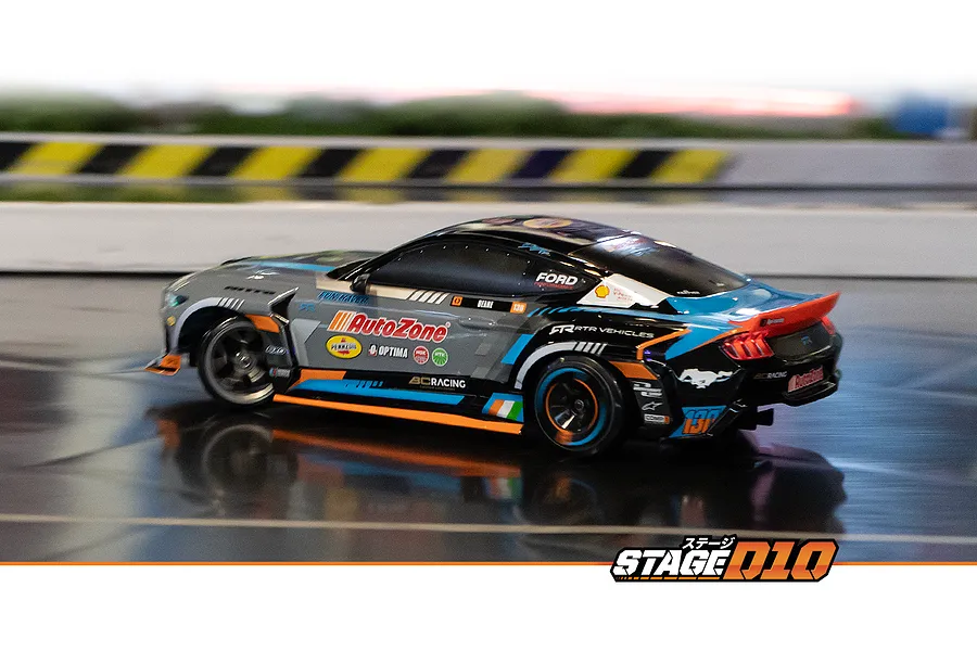 HPI Stage-D10 Ford Mustang GT Spec-5 FD RC drift car driving on an indoor track with racing livery.