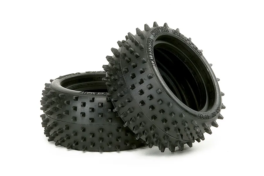 Two black rubber Tamiya 1/10 square spike rear RC buggy tyres shown against a clean white background.