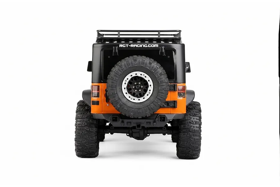 Rear view of the RGT Rock Cruiser Evolution V3 1/10 scale RC rock crawler, featuring an orange and black body with a spare tire mounted on the back.