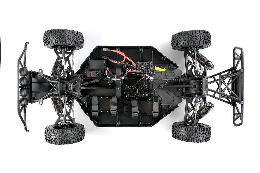 Top-down view of the Rovan ELT320S V2 RC short course truck chassis, showing electronics, suspension, and tires on a white background.