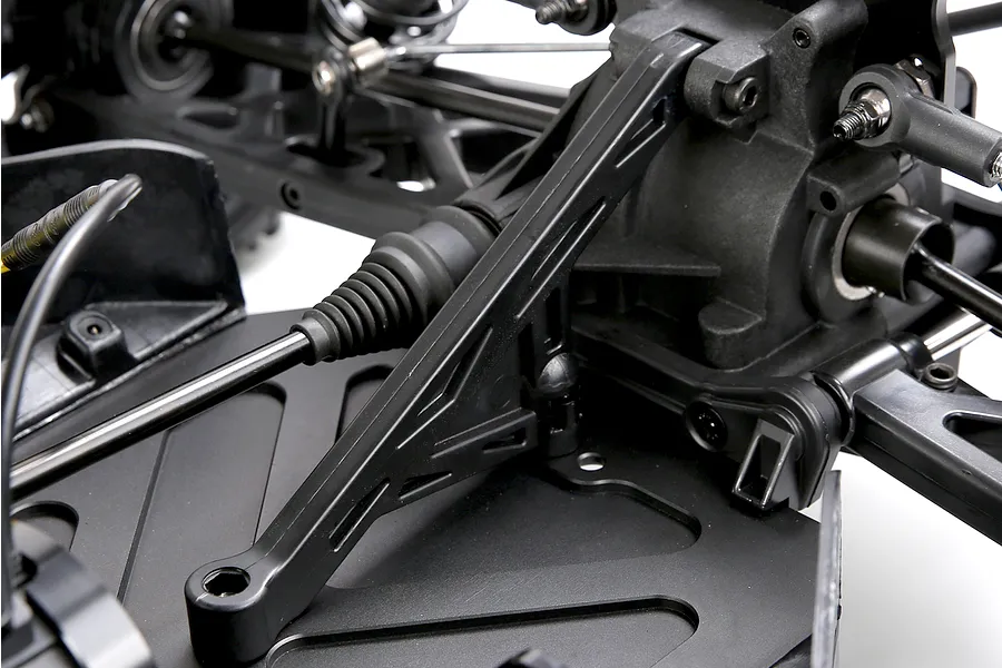 Close-up view of the chassis, differential housing, and suspension components on the Rovan ELT320S V2 RC short course truck.