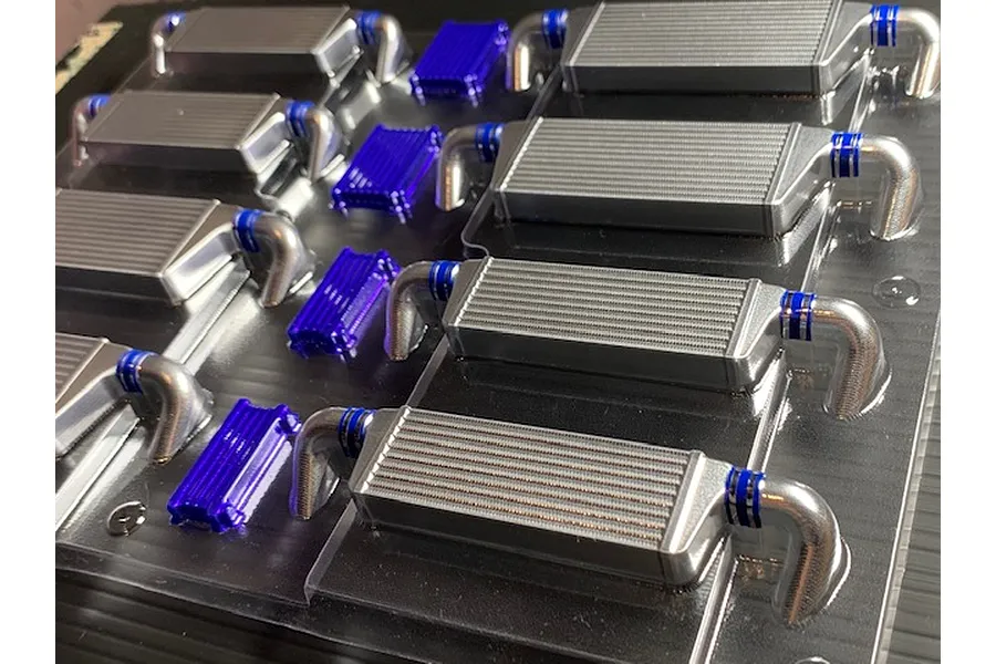 Pandora RC unpainted polycarbonate lightweight intercooler set parts molded on a clear sheet with blue details.