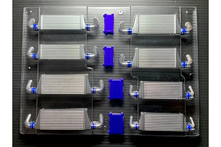 Uncut polycarbonate RC body accessory sheet containing multiple intercoolers and oil cooler parts in silver and purple.