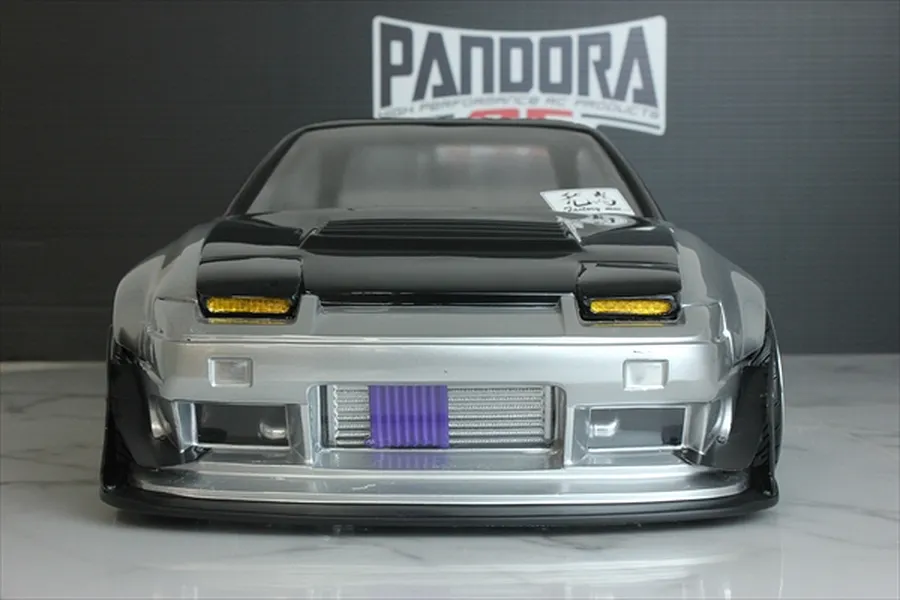 Front view of an RC drift car body installed with a detailed front-mounted intercooler accessory behind the bumper opening.