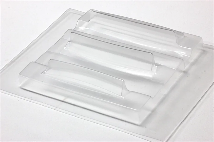 Unpainted clear polycarbonate ducktail spoiler set from Pandora RC shown against a neutral white background.