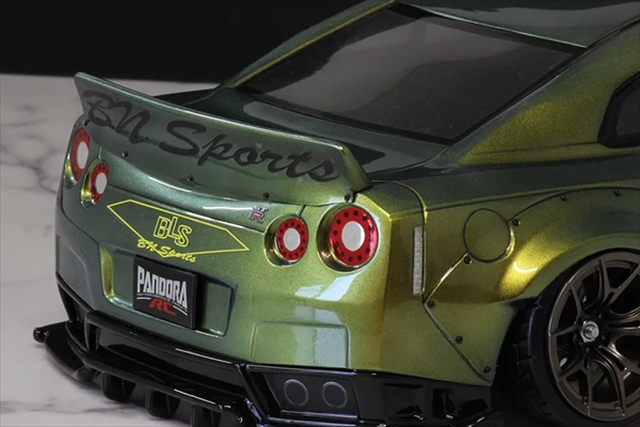 Rear view of an RC drift car body featuring a ducktail spoiler with BN Sports branding mounted on the trunk.