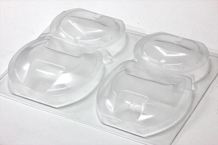 Unpainted clear polycarbonate over fender set sheet on a white background.