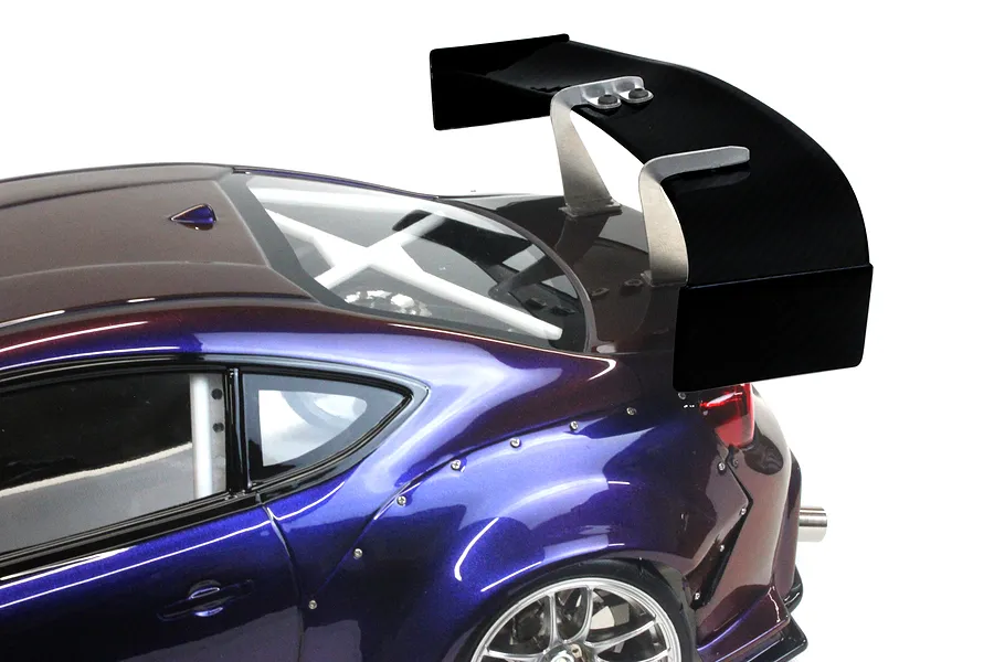 Close-up of a Pandora RC GT Wing Set mounted on the rear trunk of a metallic purple RC drift car body shell against a white background.