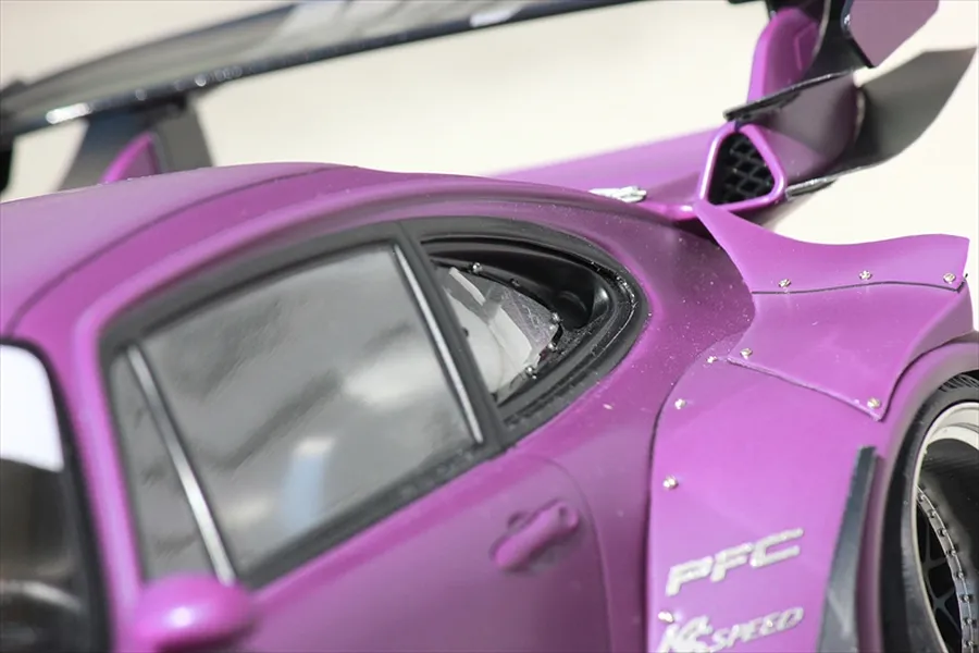 Close-up of the rear quarter section and wide fender set installed on a purple RC car body shell.