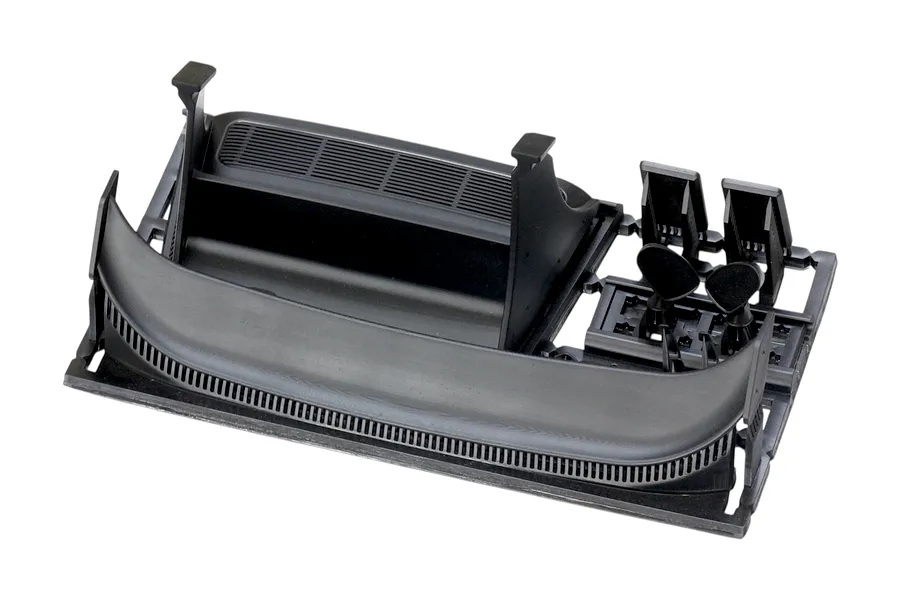 Unpainted black plastic RC car spoiler and accessories parts tree on a white background.