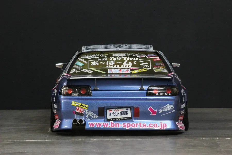Rear view of a blue Pandora RC HCR32 Skyline body shell featuring custom decals, a rear spoiler, twin exhaust pipes, and BN-Sports branding.