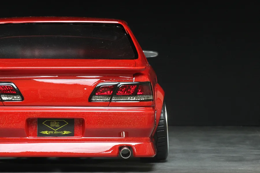 Rear view of a red Pandora RC Toyota Cresta JZX100 drift body shell featuring detailed taillights and an exhaust tip.