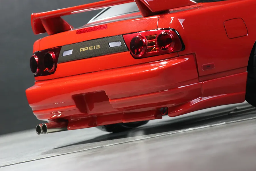 Close up of the rear end of a red Pandora RC RPS13 180SX Kouki drift car body shell, showing taillights and dual exhaust tips.