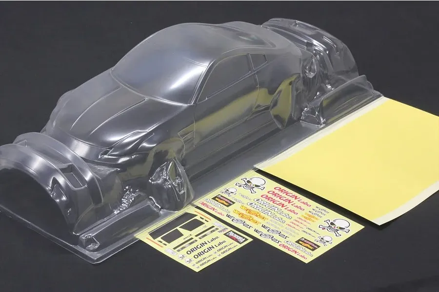 Unpainted clear polycarbonate RC car body shell of a Nissan 350Z Fairlady with decal sheets and masking film.