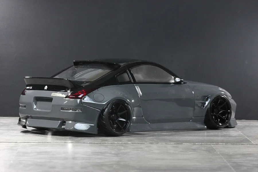 Rear three-quarter view of a gloss grey RC drift car body styled as a Nissan 350Z with black roof, spoiler, and wheels.