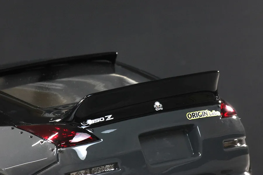 Rear close up of the Pandora RC 350Z Fairlady body shell showing the black spoiler, taillights, and decals.