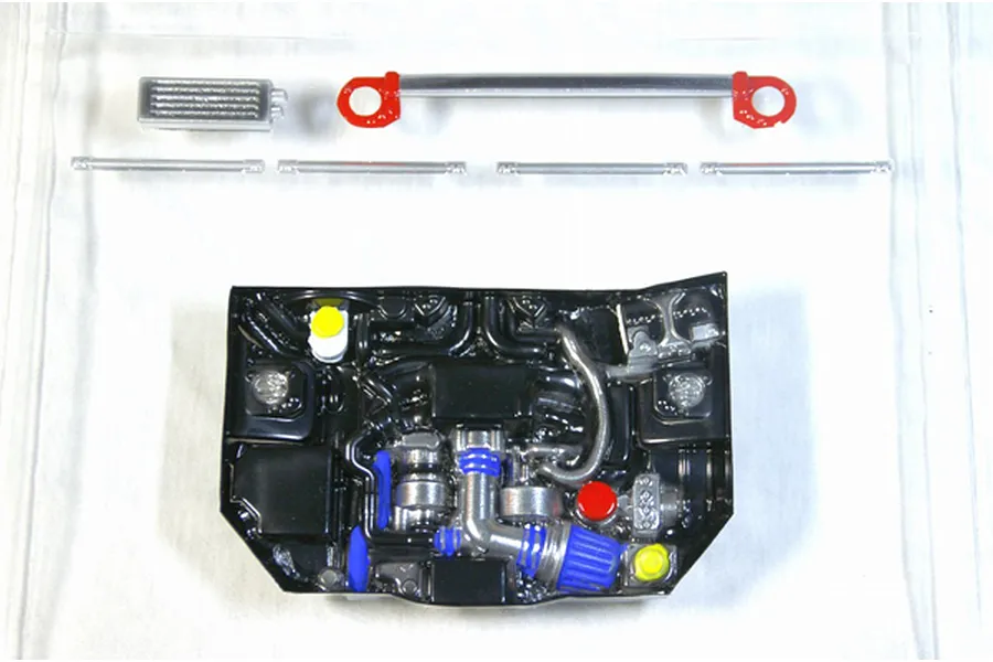 Pandora RC scale engine bay detail set including molded engine block, strut brace, and accessories on a white surface.