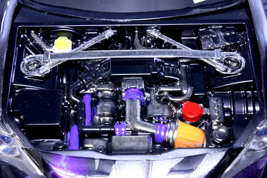 Detailed top-down view of an installed RC scale model engine bay accessory set with custom painted details.