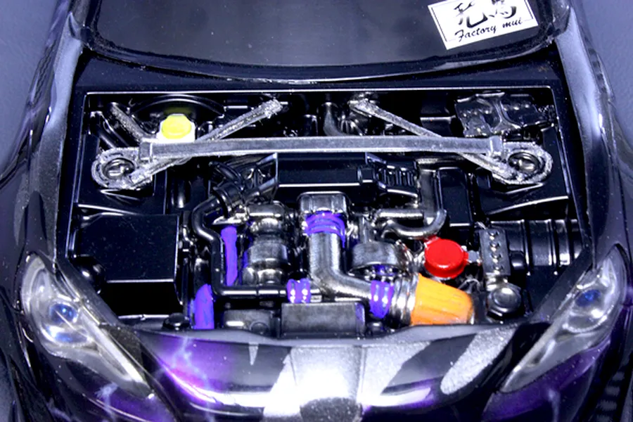 Detailed model car engine bay featuring an installed FA engine set with strut brace, wiring, and custom parts inside a black vehicle.