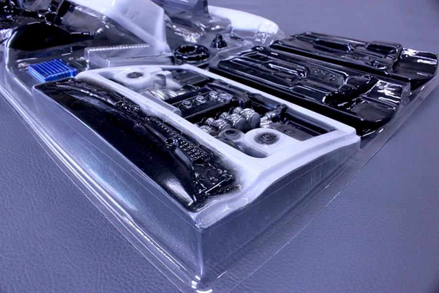 Pandora RC general purpose interior set inside a clear plastic molding sheet on a grey surface.