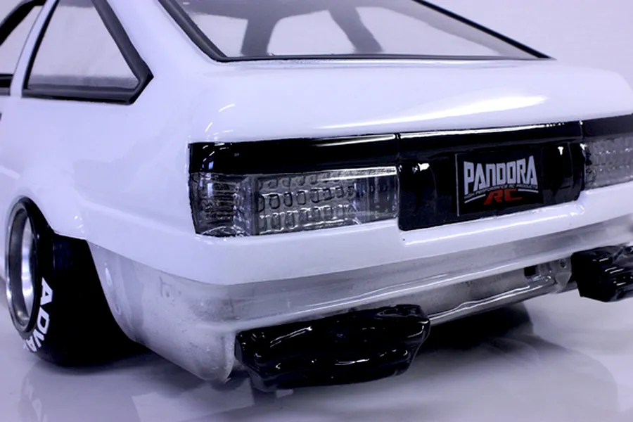 Rear view of a white RC drift car body showing detailed tail lights, black bumper trim, and Pandora RC branding.
