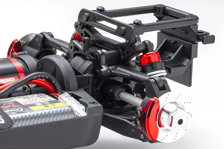 Close-up of the rear suspension, shock absorbers, brake disc, and chassis components of the Kyosho Fazer Mk2 RC car.