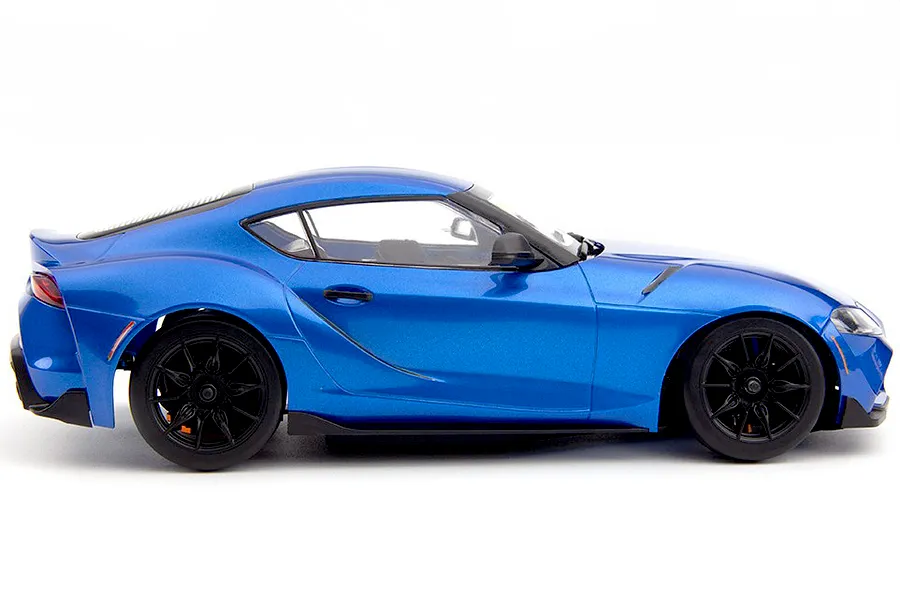 Studio side profile view of the metallic dawn blue HPI Stage D24 Toyota Supra GR RC car on a white background.