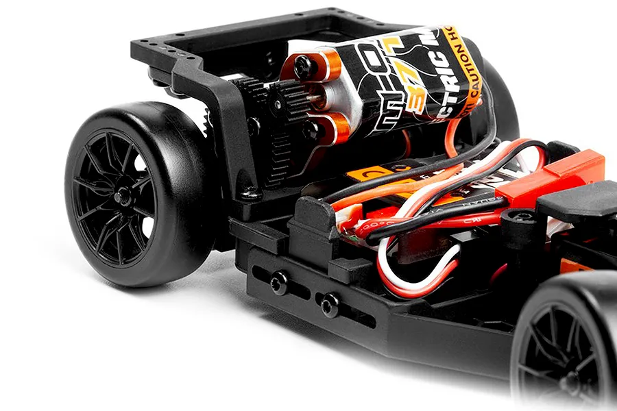 Close-up studio view of the internal chassis, motor, gears, and rear wheels of a 1/24 scale RC drift car against a white background.