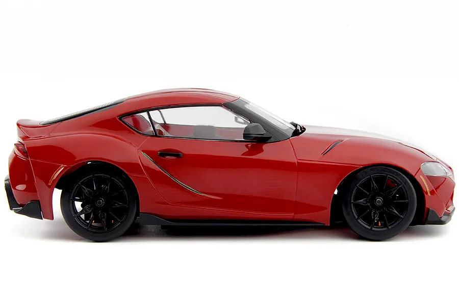 Studio side profile view of the red HPI Stage D24 Toyota Supra GR RC car on a white background.