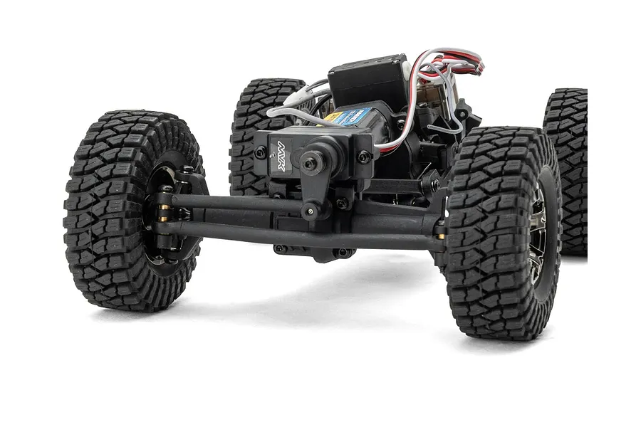 Front view of the chassis, axle, steering servo, and chunky treaded rubber tires of the Maverick Scout-24 1/24 scale RC rock crawler.