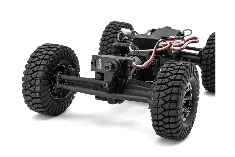 Close-up studio shot of the front steering servo and axle setup of an RC rock crawler chassis against a white background.