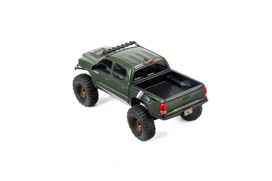 High-angle studio shot of the green Axial SCX30 Toyota Tacoma RC rock crawler truck on a clean white background.