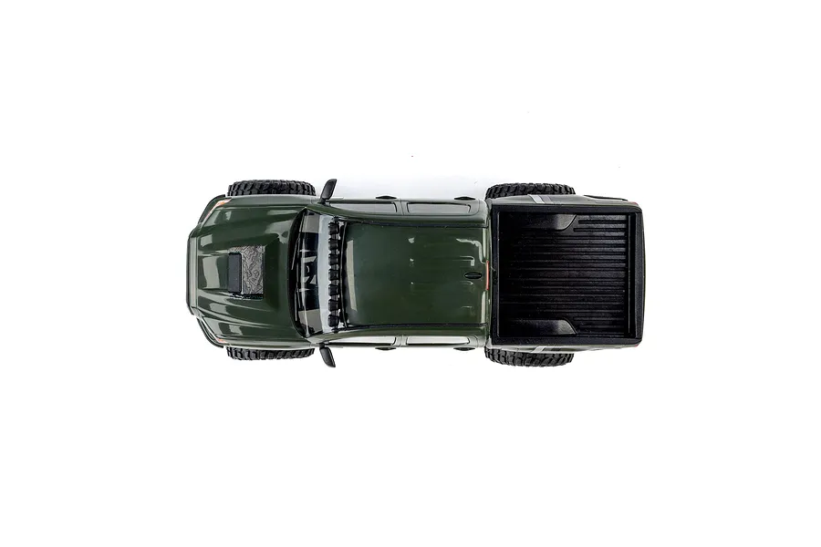 Top-down studio shot of the green Axial SCX30 Toyota Tacoma RC rock crawler truck on a white background.