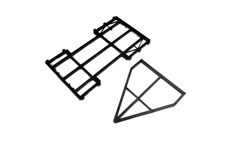 Black plastic trailer frame set components laid out on a clean white background.