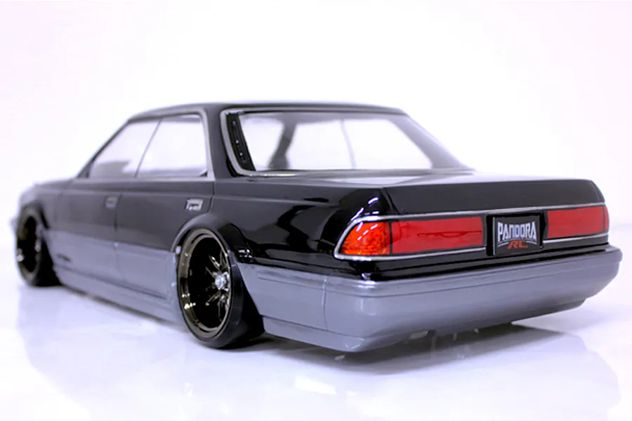 Rear three-quarter view of a painted Pandora RC Toyota Mark 2 JZX81 body shell in black and grey on a white surface.
