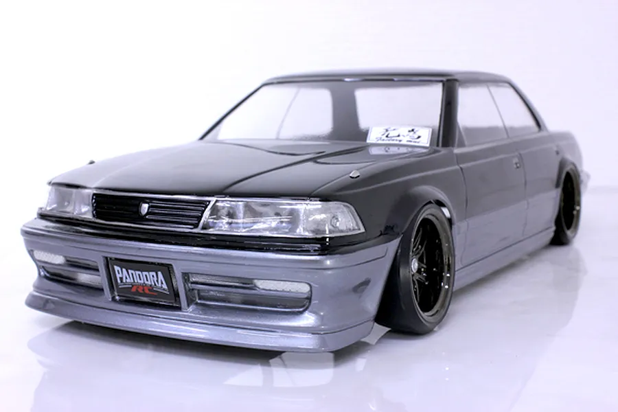 Front three-quarter view of a painted grey and black Toyota Mark II RC drift car body on a white background.