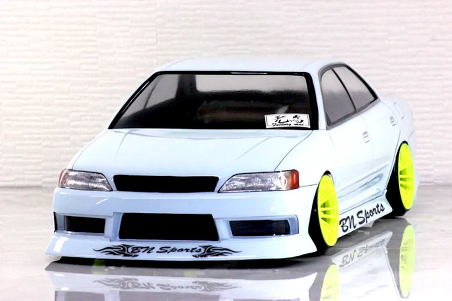 Painted Pandora RC Toyota Mark 2 JZX90 body shell with BN Sports decals and bright yellow wheels.