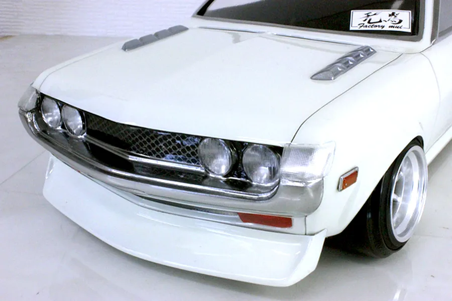 Close-up front view of a white Toyota Celica RC drift car body shell featuring a detailed chrome grille and quad headlights.