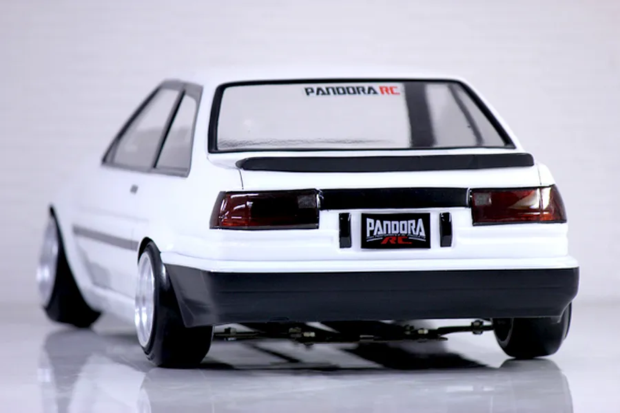 Rear view of Pandora RC Toyota AE86 Sprinter Trueno 2-door white drift RC body shell mounted on a chassis.