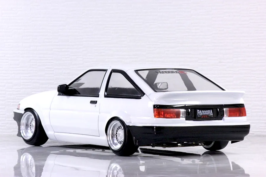 Rear three-quarter view of a white Toyota AE86 Trueno 3-door RC drift car body shell with deep dish wheels.