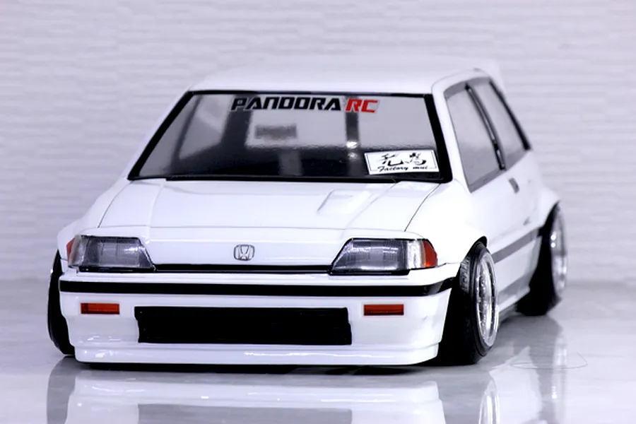 Front view of a white Honda Civic RC drift car body shell on a reflective surface with Pandora RC decals.