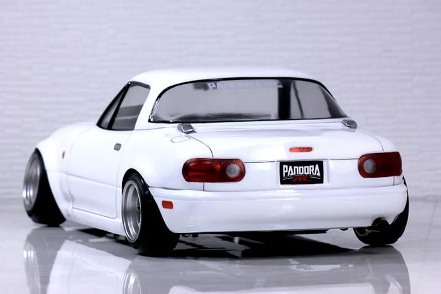 Rear three-quarter view of a white Pandora RC Mazda Eunos Roadster NA drift car body shell on a glossy surface.