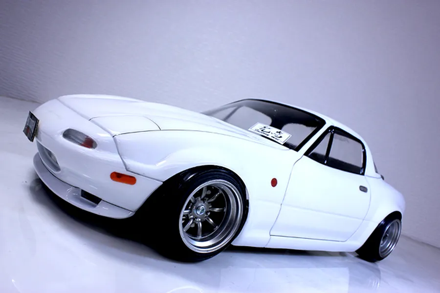Painted white RC drift car body shell modelled after a Mazda Eunos Roadster NA on a white background.